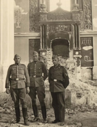 German soldiers posing inside of the burned synagogue in Lodz